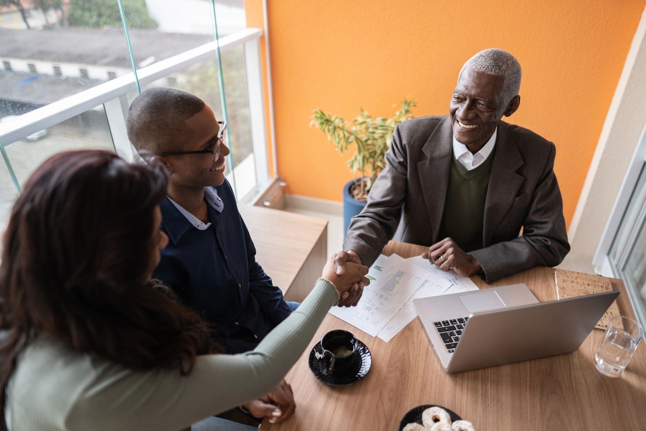 Advisor meeting with clients at home to discuss financial planning