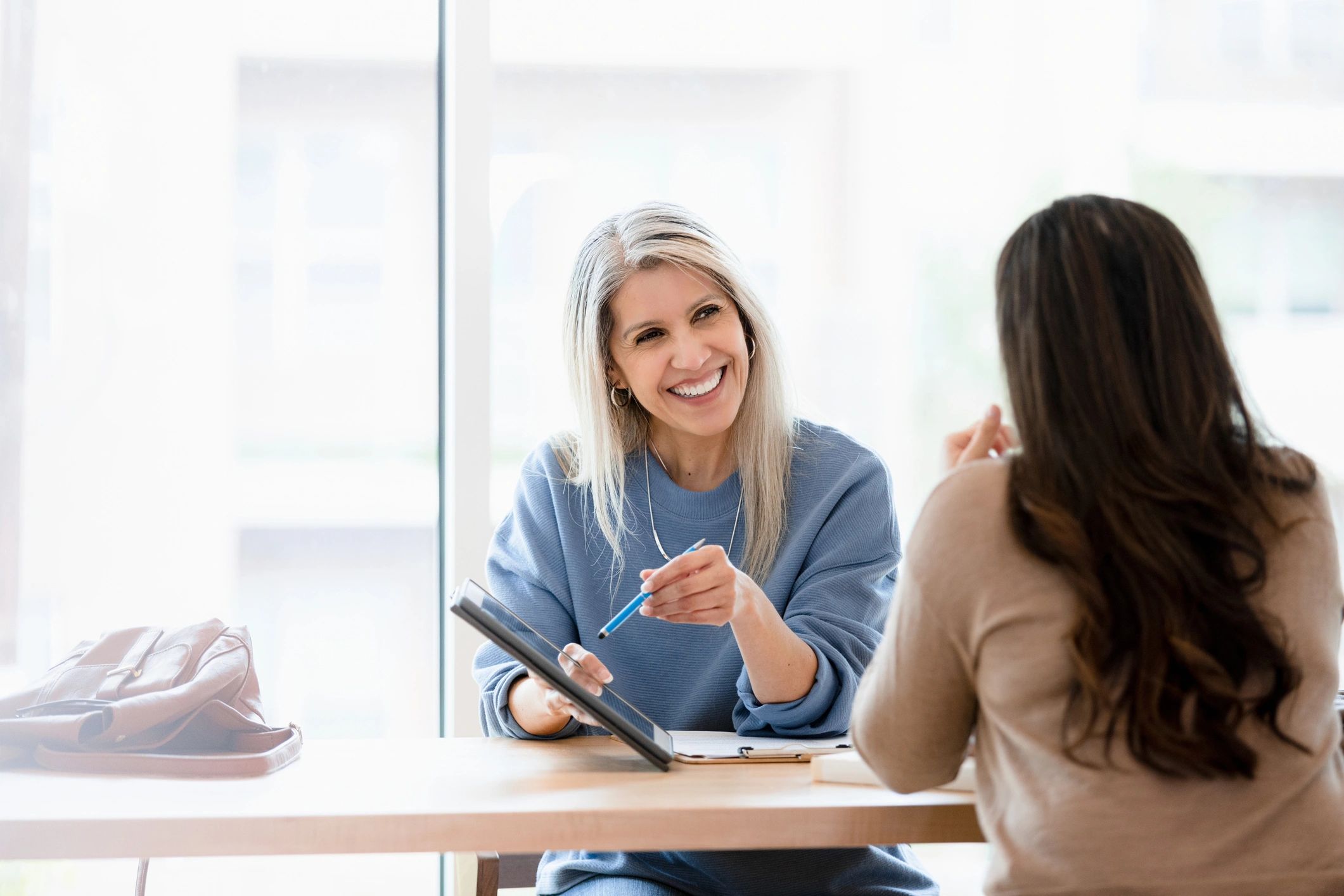 Financial advisor meeting with a client at a desk