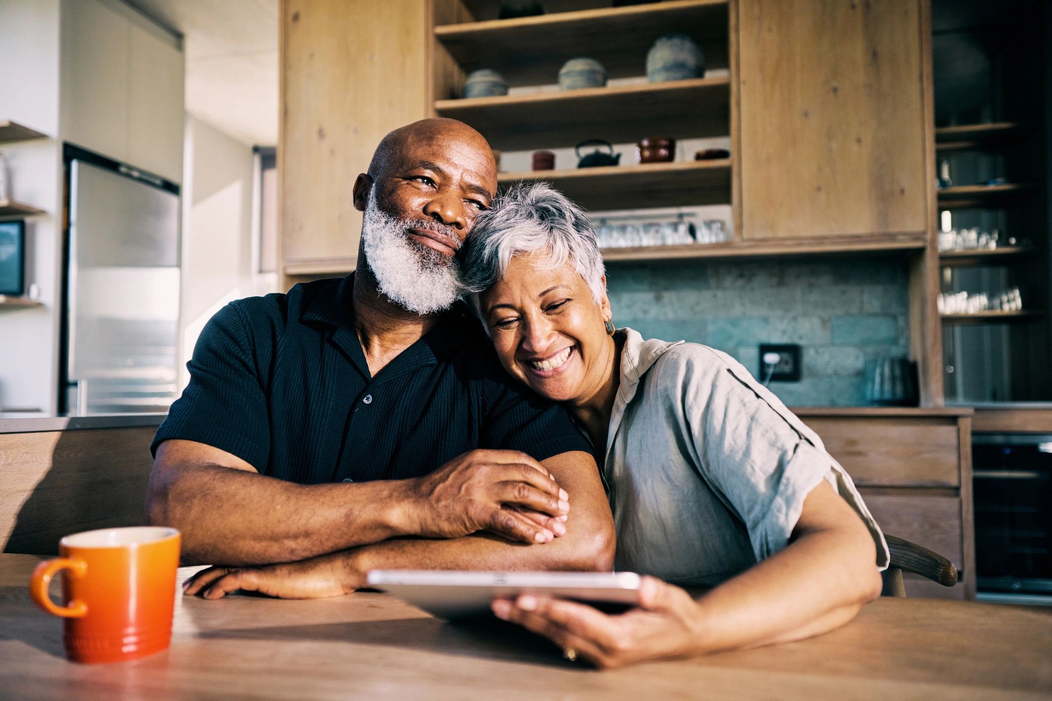 Retired couple smiling and discussing retirement plans