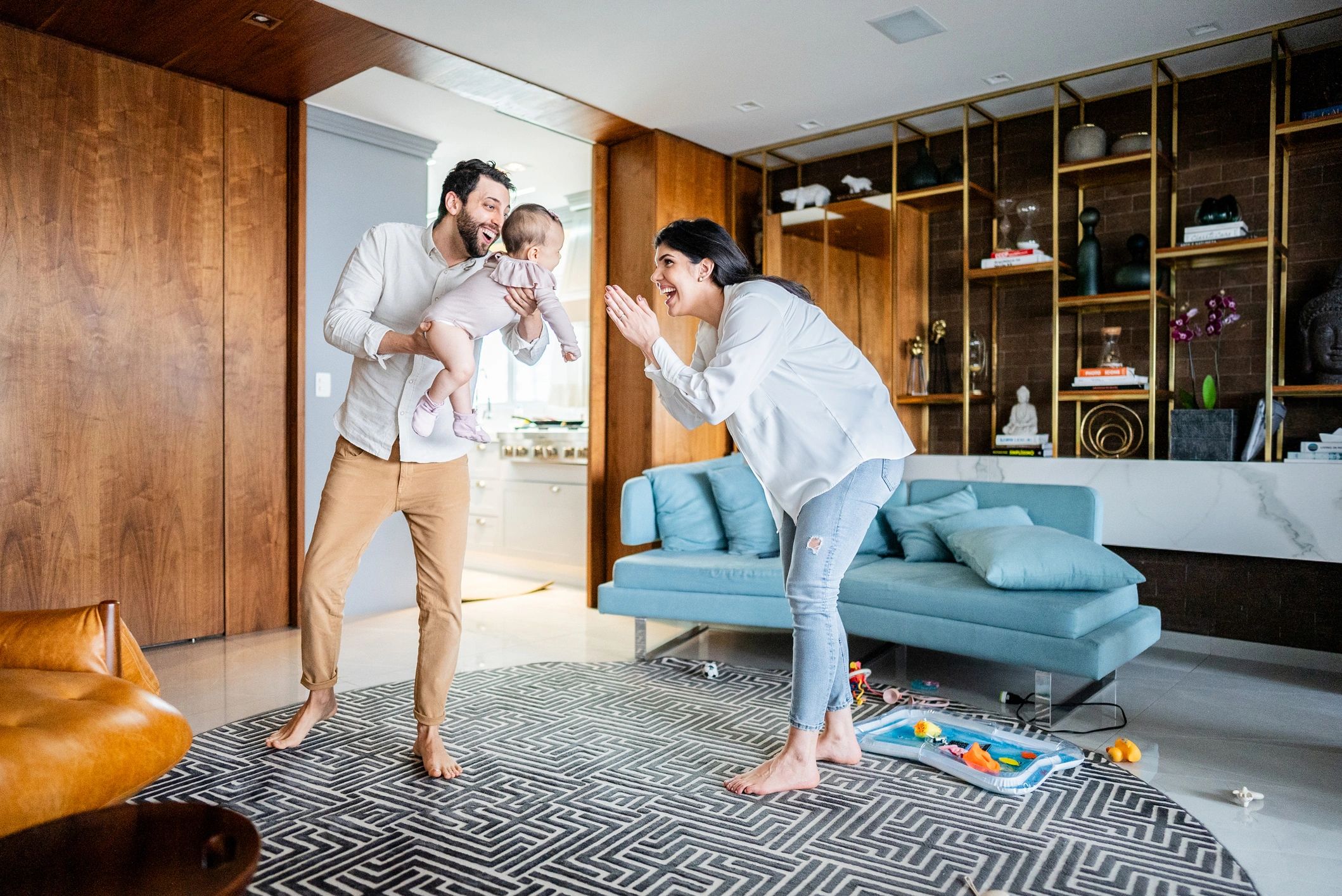 Parents playing with their child at home, representing family protection