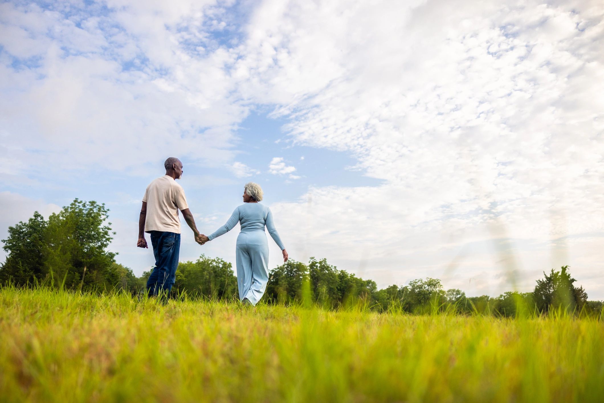 Senior couple walking outdoors representing a client testimonial